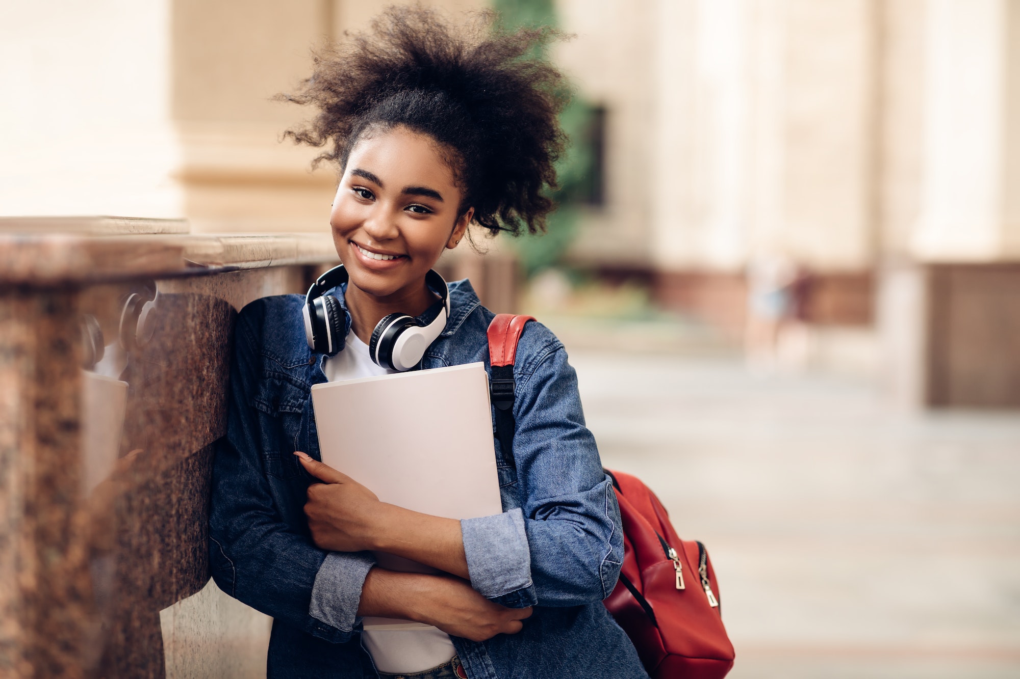 Happy African Student Girl Holding Books Posing Near University Building