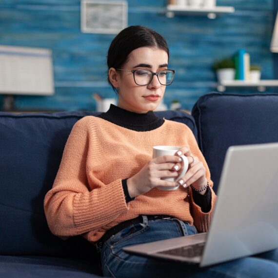 Student reading marketing courses drinking cup of coffee